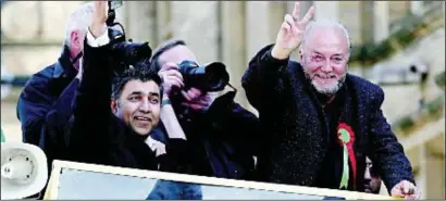  ?? PHOTO: PA ?? A victorious George Galloway MP, right, rides through Bradford after his landslide win in Bradford West