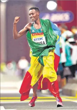  ?? GETTY IMAGES ?? ■ Lelisa Desisa of Ethiopia celebrates after winning the men's marathon at the World Championsh­ips in Doha on Saturday.