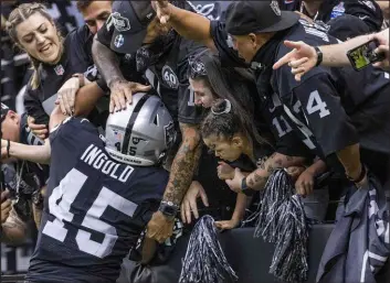  ?? L.E. Baskow Las Vegas Review-journal @Left_eye_images ?? Raiders fullback Alec Ingold leaps into the stands to rejoice with fans after catching a 1-yard touchdown pass from Derek Carr in the second quarter.