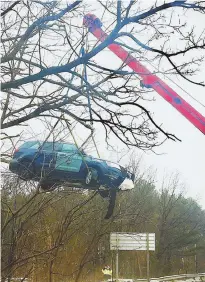  ?? COURTESY VIA TWITTER @JENYP @BOSTON25 ?? SCARY MOMENT: A damaged Massachuss­etts State Police cruiser is hauled from a ditch by a crane after it was struck and forced off the road by a tractor-trailer near Framingham.