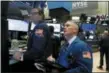  ?? RICHARD DREW — THE ASSOCIATED PRESS ?? Specialist Gregg Maloney, left, and trader Timothy Nick work on the floor of the New York Stock Exchange, Wednesday.