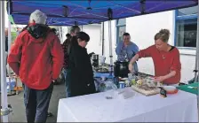  ?? 01_B21coast14_23_zero_waste ?? Ruth McLaren serves up cake at the Zero Waste Cafe.