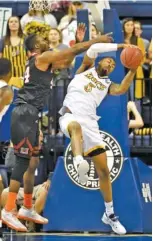  ?? STAFF PHOTO BY ROBIN RUDD ?? UTC’s Justin Tuoyo steals a Mercer pass intended for JJ N’Ganga during Saturday’s game. The Bears dealt the Mocs their third consecutiv­e defeat.