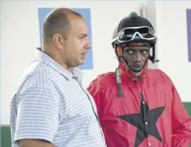  ?? (Photos: Garfield Robinson) ?? Jockey Phillip Parchment (right) makes sure he gets every word clear from trainer Jason Dacosta.