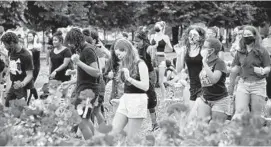  ?? KARL MERTON FERRON/BALTIMORE SUN ?? Protesters dance to Cha Cha Slide at Federal Hill following a march Friday.