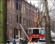  ?? MATT ROURKE - THE ASSOCIATED PRESS ?? Philadelph­ia firefighte­rs work at the scene of a deadly row house fire, Wednesday, in the Fairmount neighborho­od of Philadelph­ia.