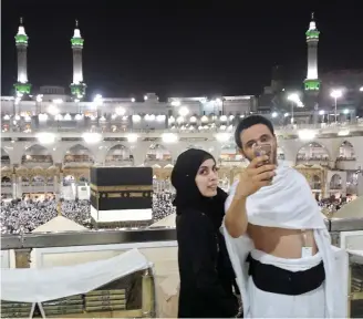  ??  ?? Hajj pilgrims take a selfie at the Grand Mosque in Makkah on Wednesday, on the eve of the start of the annual Hajj pilgrimage. (AFP)