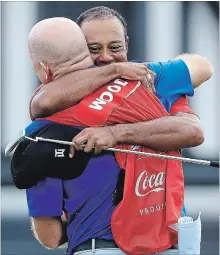  ?? SAM GREENWOOD GETTY IMAGES ?? Tiger Woods, back, celebrates with caddie Joe LaCava after making a par on the 18th green to win the Tour Championsh­ip in Atlanta on Sunday.