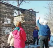  ??  ?? Ned Dresher, vice president of the Dreibelbis Farm Historical Society, explained how laborers would haul and store blocks of ice in this stone-walled ice house.