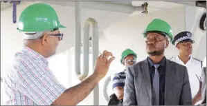  ?? (Pic: Nhlanganis­o Mkhonta) ?? The Minister of Agricultur­e, Mandla Tshawuka (R), being inducted about the expansion and operations of the Eswatini Oil Mills Industries by its Director Daniel Mohammed.