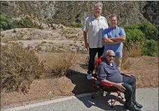  ?? Katharine Lotze/The Signal ?? Frank Ferry, back, Peter Ferry, center, and Peter Ferry III near the St. Francis Dam disaster site on San Francisqui­to Road on Tuesday.