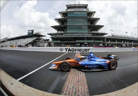  ?? Jamie Squire/Getty Images ?? Scott Dixon passes in front of the fabled pagoda Saturday to win the NTT IndyCar Series GMR Grand Prix at Indianapol­is Motor Speedway — the first race in a historic IndyCar/NASCAR weekend at the track.