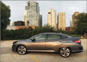  ?? ROBERT DUFFER/CHICAGO TRIBUNE ?? The 2018 Honda Clarity plug-in hybrid vehicle is the volume product in Honda’s 3-in-1 electrific­ation strategy, which also includes a hydrogen fuel cell car and full battery electric vehicle. Clarity is a compact sedan with a 42-mile all-electric...