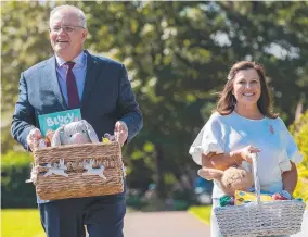  ?? ?? Prime Minister Scott Morrison and his wife Jenny, above, visiting Westmead Children’s Hospital, Sydney; and, right, Morrison with Jenny and daughters Abbey, 14, and Lily, 12, and their dog Buddy at Kirribilli House, Sydney.