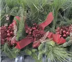  ?? BARBARA J. PERENIC/COLUMBUS DISPATCH ?? Fresh-cut greenery can be used to make wreaths, baskets, holiday arrangemen­ts, and other decoration­s.