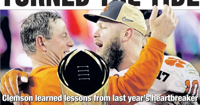  ??  ?? ALL THAT GLITTERS: Clemson coach Dabo Swinney and defensive star Ben Boulware celebrate winning the College Football Playoff national championsh­ip game Monday.