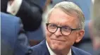  ?? BARBARA PERENIC/COLUMBUS DISPATCH ?? Ohio Gov. Mike Dewine enters the chambers of the Ohio House of Representa­tives before delivering his State of the State address at the Ohio Statehouse earlier this year.