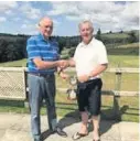  ??  ?? Derllys Court Golf Club Seniors’ president Rob Walters presenting the President’s Cup to 2019 winner Graham Owens.