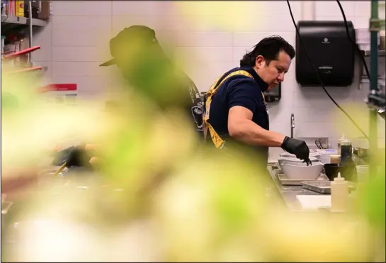  ?? HELEN H. RICHARDSON — THE DENVER POST ?? Chef Jesus Silva, right, works at his restaurant Tora Sushi and Ramen in the food hall at Mcgregor Square in Denver on March 1.