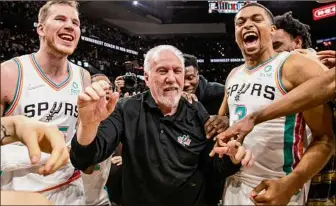  ?? William Luther / San Antonio Express-News ?? San Antonio Spurs coach Gregg Popovich celebrates Friday at AT&T Center in San Antonio with Spurs center Jakob Poeltl, left, and Spurs forward Keldon Johnson after the Spurs beat the Utah Jazz to give Popovich 1,336 regular-season wins, the most in NBA history.