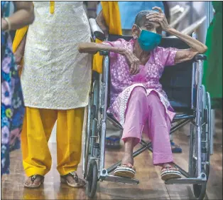  ?? (AP/Rafiq Maqbool) ?? An elderly woman waits to receive the vaccine for covid-19 at a vaccinatio­n center in Mumbai.