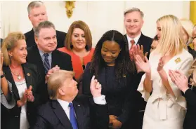  ?? Andrew Caballero-Reynolds / AFP via Getty Images ?? President Trump acknowledg­es Bella Hounakey, a survivor of human traffickin­g, after signing an executive order on combating human traffickin­g.