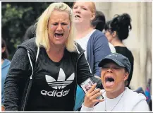  ??  ?? TEARS: Supporters weep outside the court after yesterday’s announceme­nt and Charlie in hospital