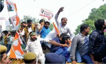  ??  ?? Activists of Youth Congress protest against Bharatiya Janata Party president Amit Shah and his son Jay Shah in New Delhi on Friday. — BUNNY SMITH