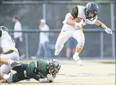  ?? Steph Chambers/Post-Gazette ?? Thomas Jefferson's Dan Deabner breaks free for yardage as Belle Vernon's Nolan Labuda attempts a tackle in their game Sept. 7.