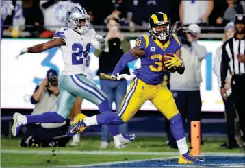  ?? ASSOCIATED PRESS ?? LOS ANGELES RAMS running back Todd Gurley scores past Dallas Cowboys cornerback Chidobe Awuzie during the first half in a divisional football playoff game Saturday in Los Angeles.