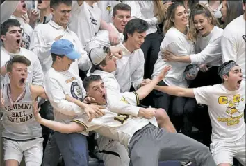  ?? Matt Freed/Post-Gazette ?? DID THEY REALLY? Central Catholic students celebrate as their team takes the lead against Butler in the fourth quarter of the teams’ Class 6A showdown at Central Catholic High School. The Vikings went on to win, 61-54, to claim the Section 1 title.