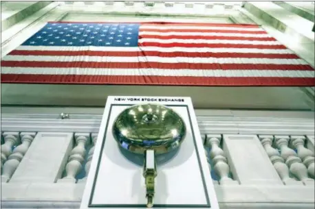  ?? RICHARD DREW — THE ASSOCIATED PRESS ?? FILE- In this file photo an American flag hangs above the bell podium on the floor of the New York Stock Exchange. The U.S. stock market opens at 9:30 a.m. EDT on Monday, June 4.