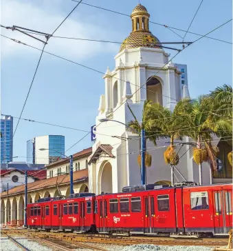  ??  ?? SAN DIEGO’S SPANISH COLONIAL Revival railway station opened in March 1915 as the Santa Fe Depot, right; strolling along the Point Loma hillside at the Cabrillo National Monument, opposite top; the Unconditio­nal Surrender statue at the USS Midway,...