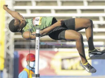  ??  ?? Dishaun Lamb of Calabar High wins the decathlon high jump with a leap of 1.92m.