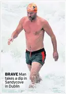  ??  ?? BRAVE Man takes a dip in Sandycove in Dublin