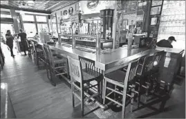  ?? CHRIS SWEDA/CHICAGO TRIBUNE ?? With restrictio­ns on capacity in place at Chicago restaurant­s, the bar area at Hopleaf, 5148 N. Clark St. in Andersonvi­lle, is empty Sept. 11.