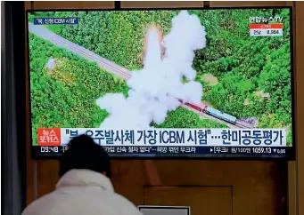  ?? AP ?? A man at a Seoul train station watches a news report about North Korea’s latest missile launches. The US and South Korean militaries have concluded that the North is testing a new interconti­nental ballistic missile system.