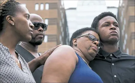  ?? Shaban Athuman/The Dallas Morning News via Associated Press ?? Brandt Jean, brother of Botham Jean, is comforted by his mother, Allison Jean, second from right, as his sister, Allisa Charles-Findley, left and her husband, Patrick, stand by during a news conference Monday at the Frank Crowley Courts Building in Dallas. Botham Jean was shot and killed by Dallas police Officer Amber Guyger in his apartment on Thursday.