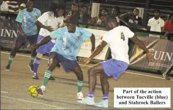 ?? ?? Part of the action between Tucville (blue) and Stabroek Ballers