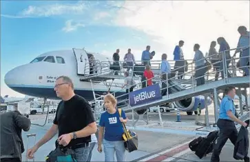  ?? Nick Ut Associated Press ?? LONG BEACH AIRPORT added nine daily departures and arrivals last year. It served 1.3 million passengers in the first half of the year, a 46.5% jump from a year earlier. Above, passengers arrive at the airport in 2014.