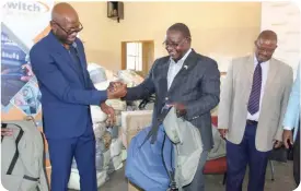  ?? ?? France Mabiletsa - SSB Managing Director (Left) handing over gifts to Council Chairman Hon BD Merementsi (Middle) with Shoshong Councillor Hon Mphoyakgos­i (Right)