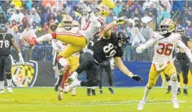  ?? ULYSSES MUÑOZ/BALTIMORE SUN ?? Defensive back Jimmie Ward defends a pass to Ravens tight end Mark Andrews. There was a question of whether it was defensive pass interferen­ce, but no flag was thrown.