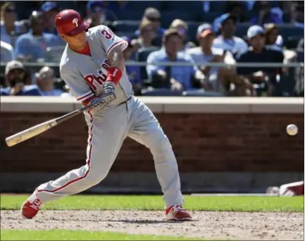  ?? FRANK FRANKLIN II — THE ASSOCIATED PRESS ?? Philadelph­ia Phillies catcher A.J. Ellis connects for a two-run double to break a seventh-inning tie against the New York Mets, Sunday in New York. The Phillies won 5-1.