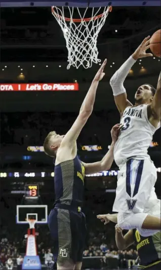  ?? MATT SLOCUM — THE ASSOCIATED PRESS ?? In this Jan. 7, 2017, file photo, Villanova’s Josh Hart, right, goes to the basket against Marquette’s Sam Hauser an NCAA college basketball game against Marquette, in Philadelph­ia.