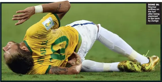  ??  ?? DONE IN: Neymar writhes on the turf after being slammed in the back by Zuniga