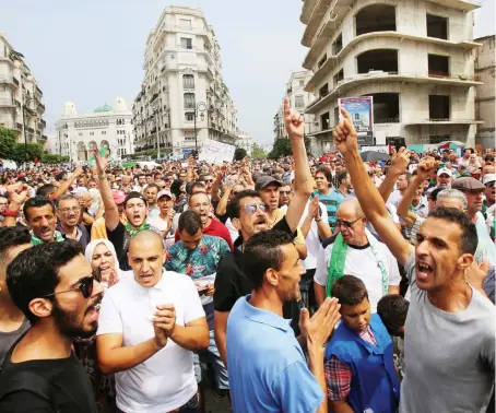  ?? Reuters ?? Demonstrat­ors gesture and shout slogans during a protest rejecting Algerian election announceme­nt for December, in Algiers.