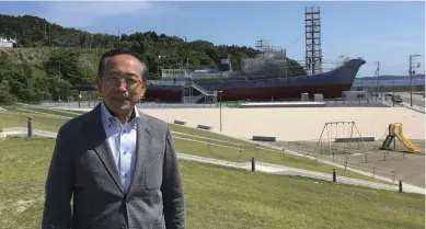  ?? ?? Left: Tomiji Saito, the head of local community developmen­t associatio­n Ayukawa Machizukur­i Kyokai in Ishinomaki, stands in front of the Toshimaru No.16, a whaling ship that survived the tsunami in 2011.