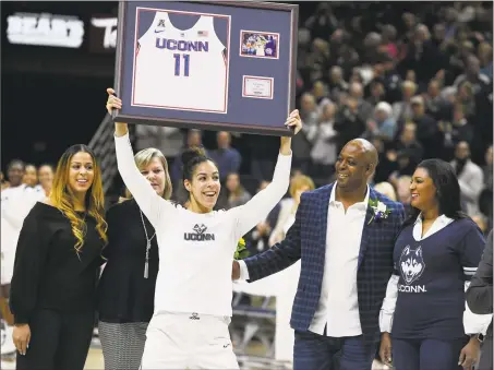  ?? Jessica Hill / Associated Press ?? UConn’s Kia Nurse holds up a jersey with her number during a Senior Night ceremony before Monday’s game in Storrs.