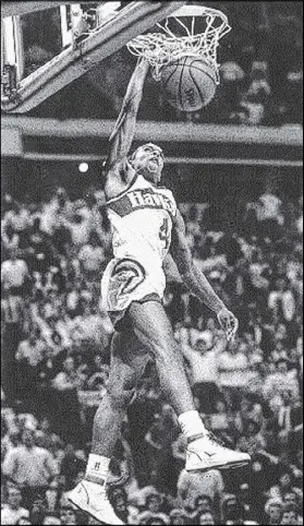  ?? FILE ?? In the NBA Slam Dunk Contest at the 1986 All-Star Game, little (5-7) Spud Webb, a rookie with the Atlanta Hawks, hits the sports stratosphe­re by beating teammate Dominique Wilkins in the finals.
