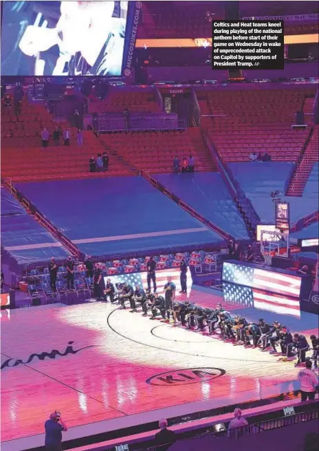  ??  ?? Celtics and Heat teams kneel during playing of the national anthem before start of their game on Wednesday in wake of unpreceden­ted attack on Capitol by supporters of President Trump.